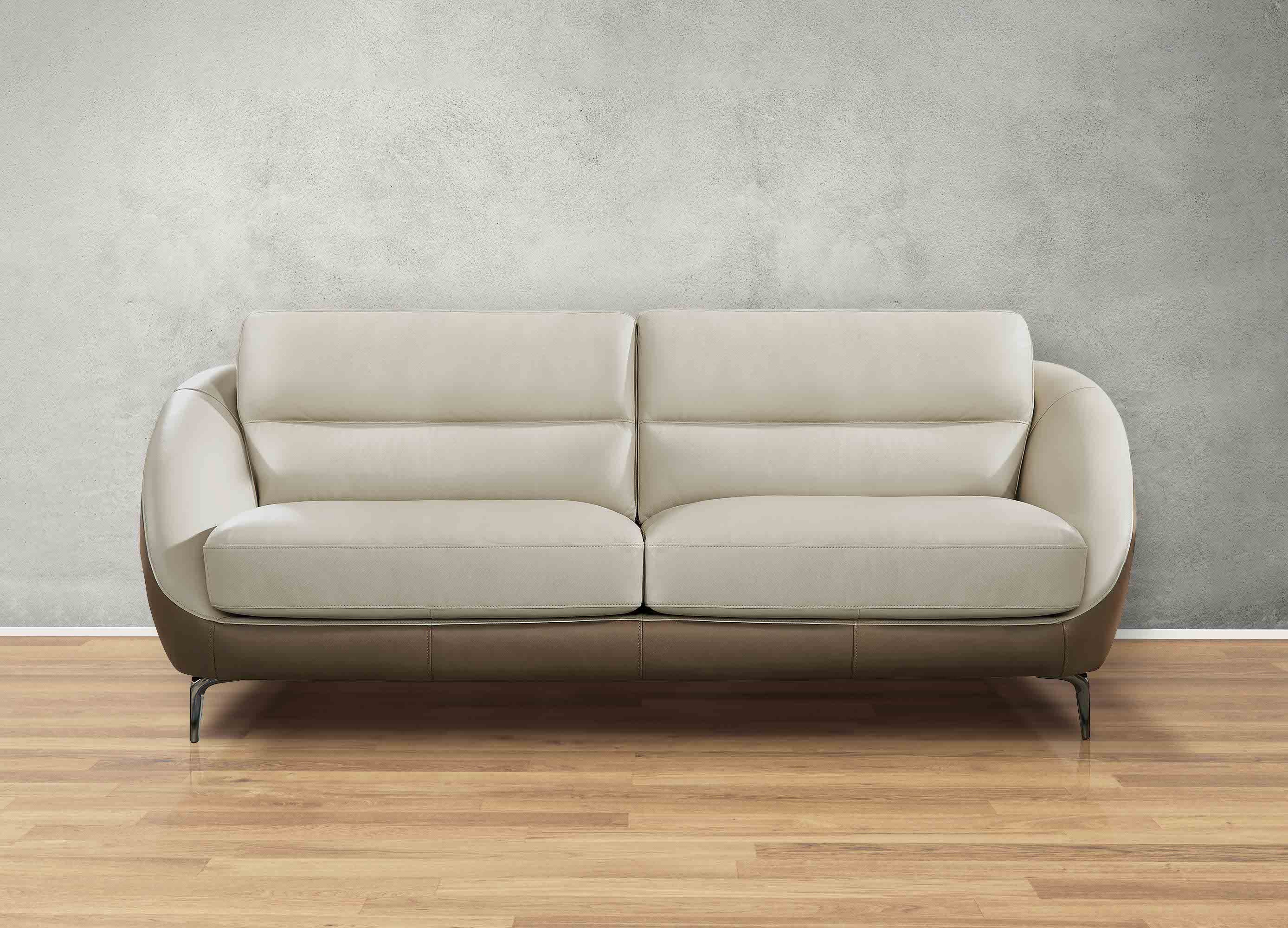 Beige sofa on a wooden floor with a gray wall background