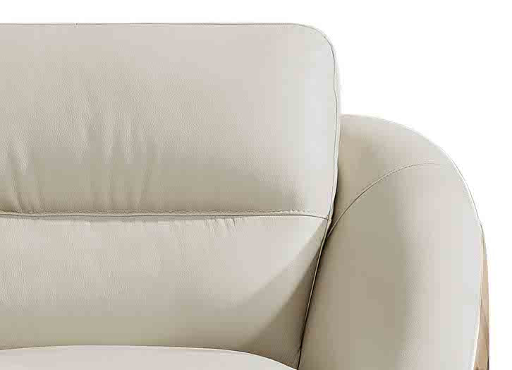 Close-up of a beige leather sofa corner on a white background