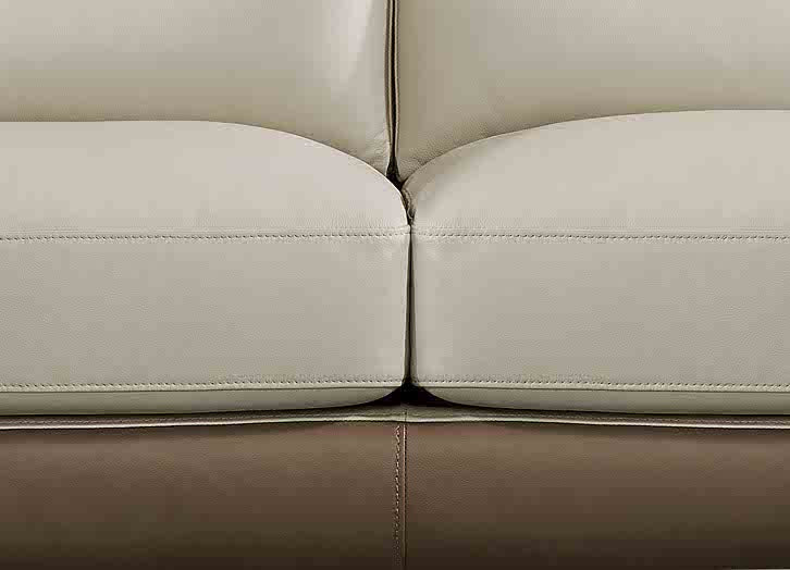Close-up of a beige leather sofa with visible stitching