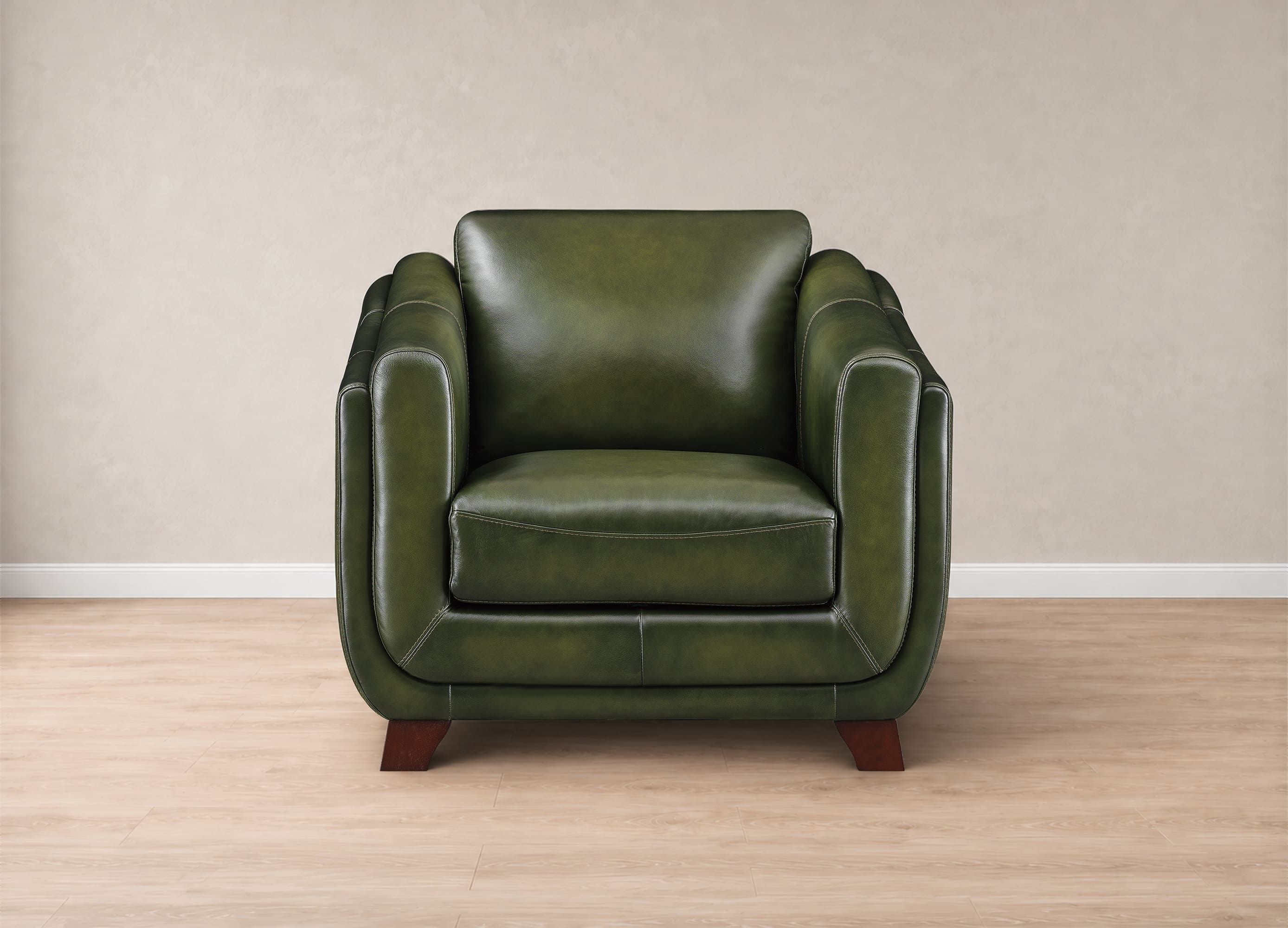 A single-seat armchair upholstered in olive green leather, positioned against a neutral beige wall on a light wood floor.