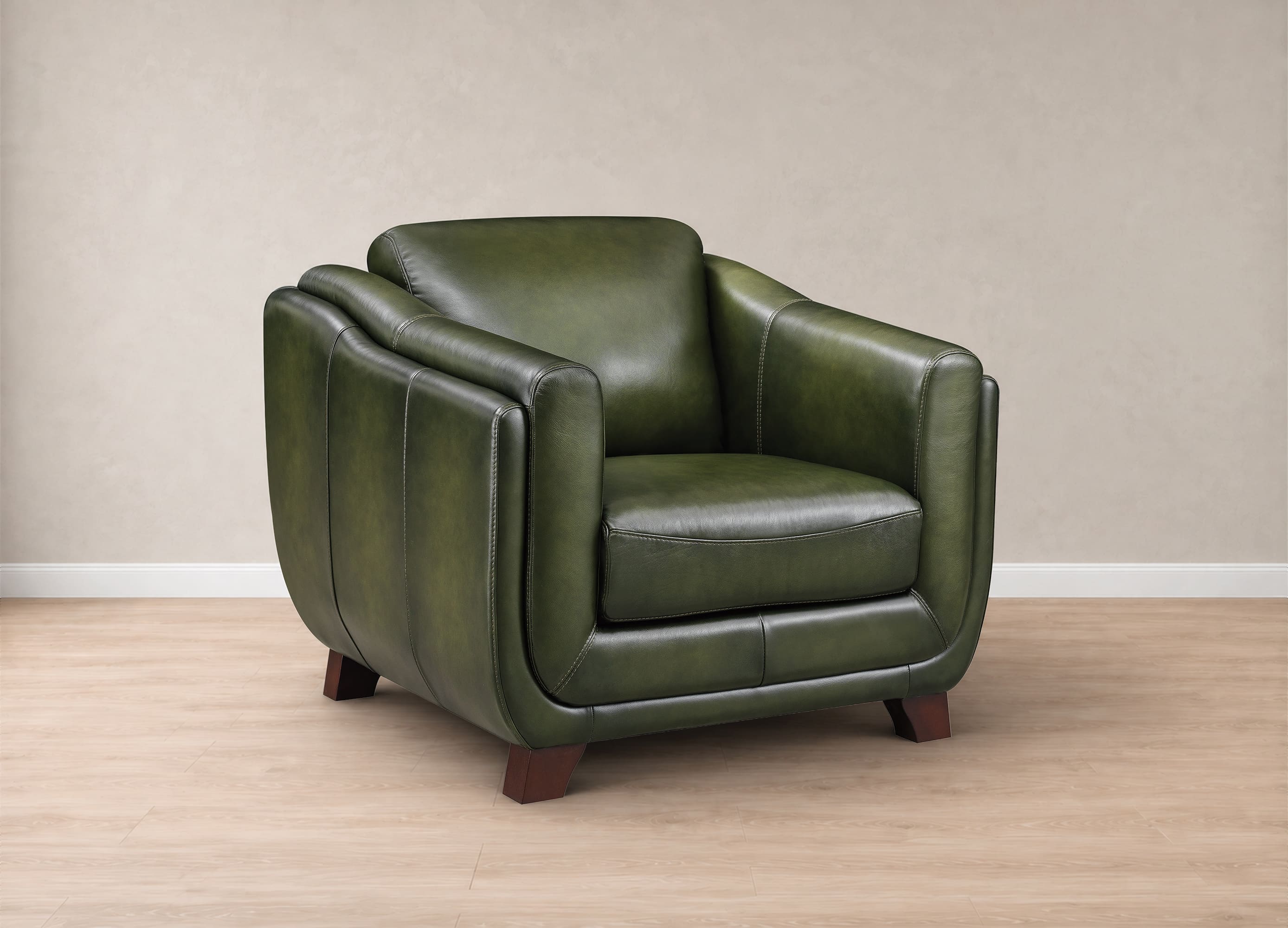 An olive green leather armchair with dark brown wooden legs, set against a neutral beige wall and light wood floor.