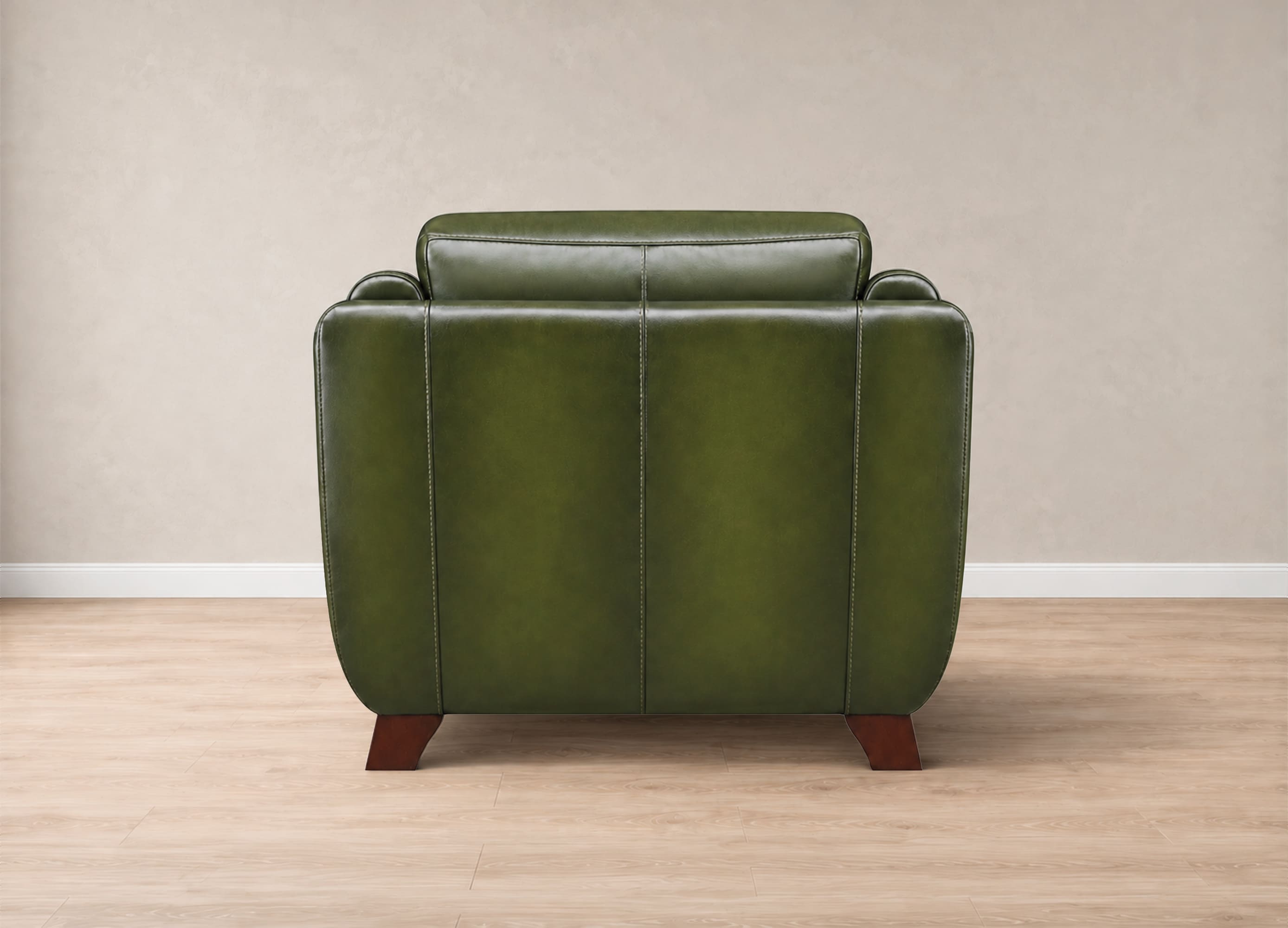 An olive green leather armchair with dark brown wooden legs, shown from the back against a neutral beige wall and light wood floor.