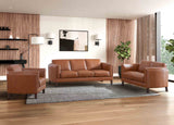 Brown leather sofa set in a modern living room with wooden floor and large windows.