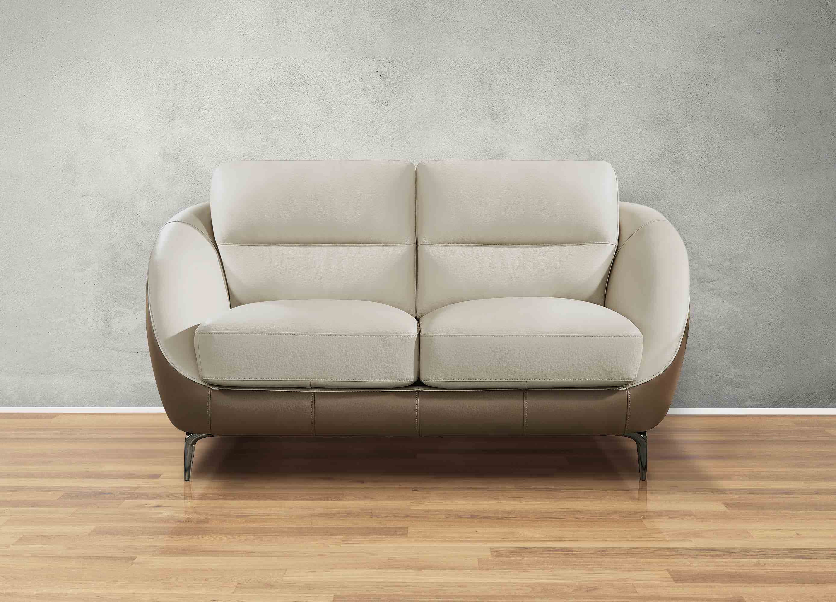 Beige sofa on a wooden floor with a gray wall background