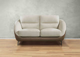 Beige sofa on a wooden floor with a gray wall background