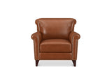 A classic brown leather armchair with rolled arms, nailhead trim, and dark wooden legs, shown against a plain white background.