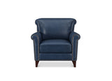 A classic wingback armchair upholstered in dark blue leather with brass nailhead trim and dark wood legs, shown against a plain white background.