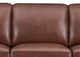 Brown leather sofa with a close-up view of the backrest.