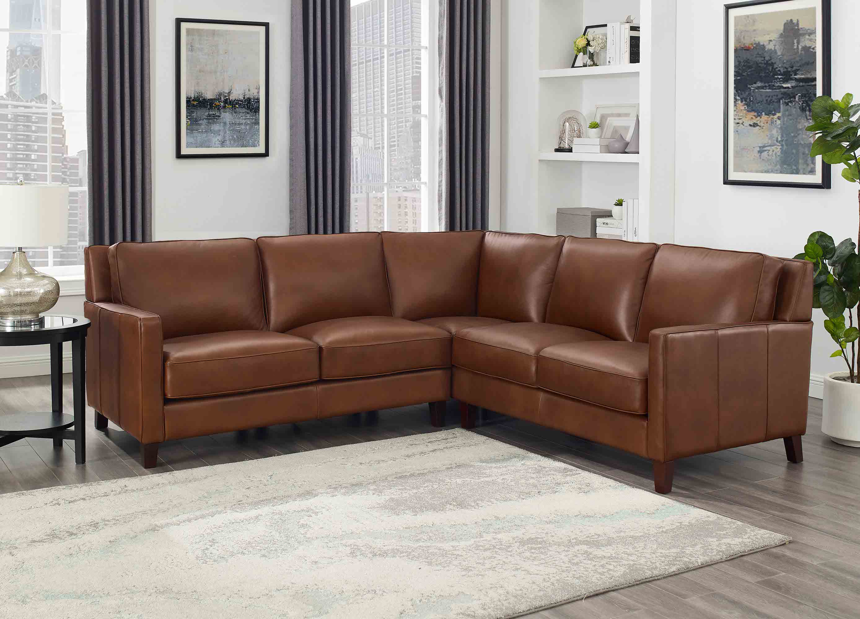 Brown leather sectional sofa in a living room setting with decor elements.