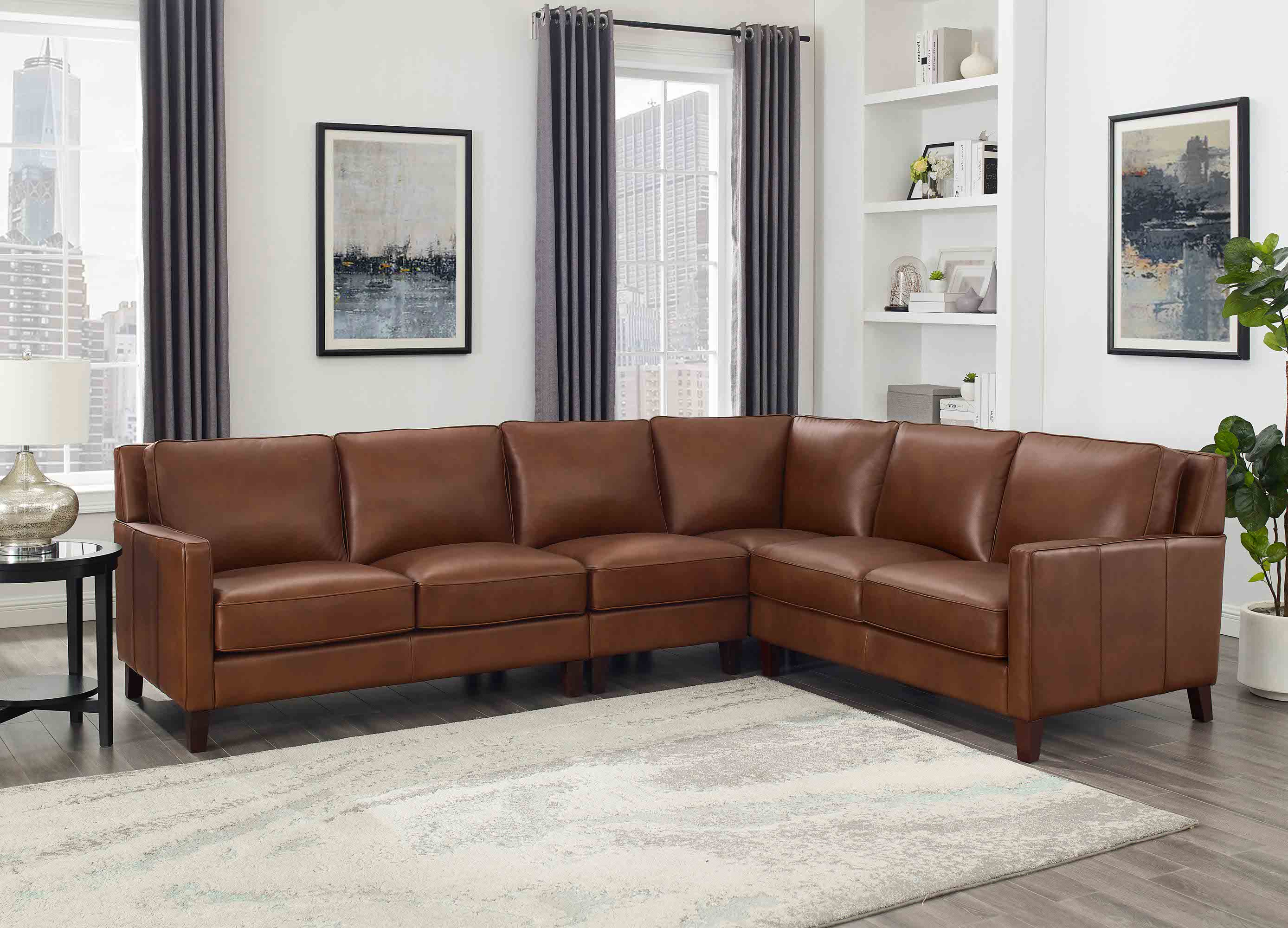Brown leather sectional sofa in a living room setting with decor elements.