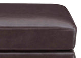 Close-up of a brown leather ottoman on a white background
