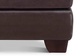 Close-up of a brown leather ottoman corner on a white background
