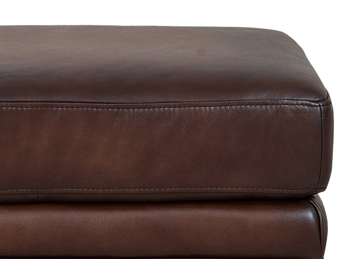 Close-up of a brown leather ottoman on a white background