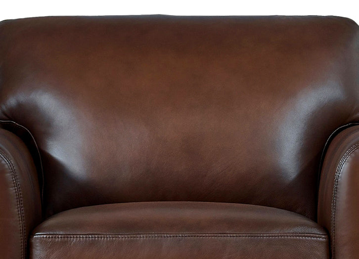 Close-up of a brown leather armchair with a white background