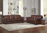 Brown leather sofa set in a living room with a bookshelf and decorative items.