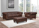 Brown leather sofa set with ottoman in a room with large windows.