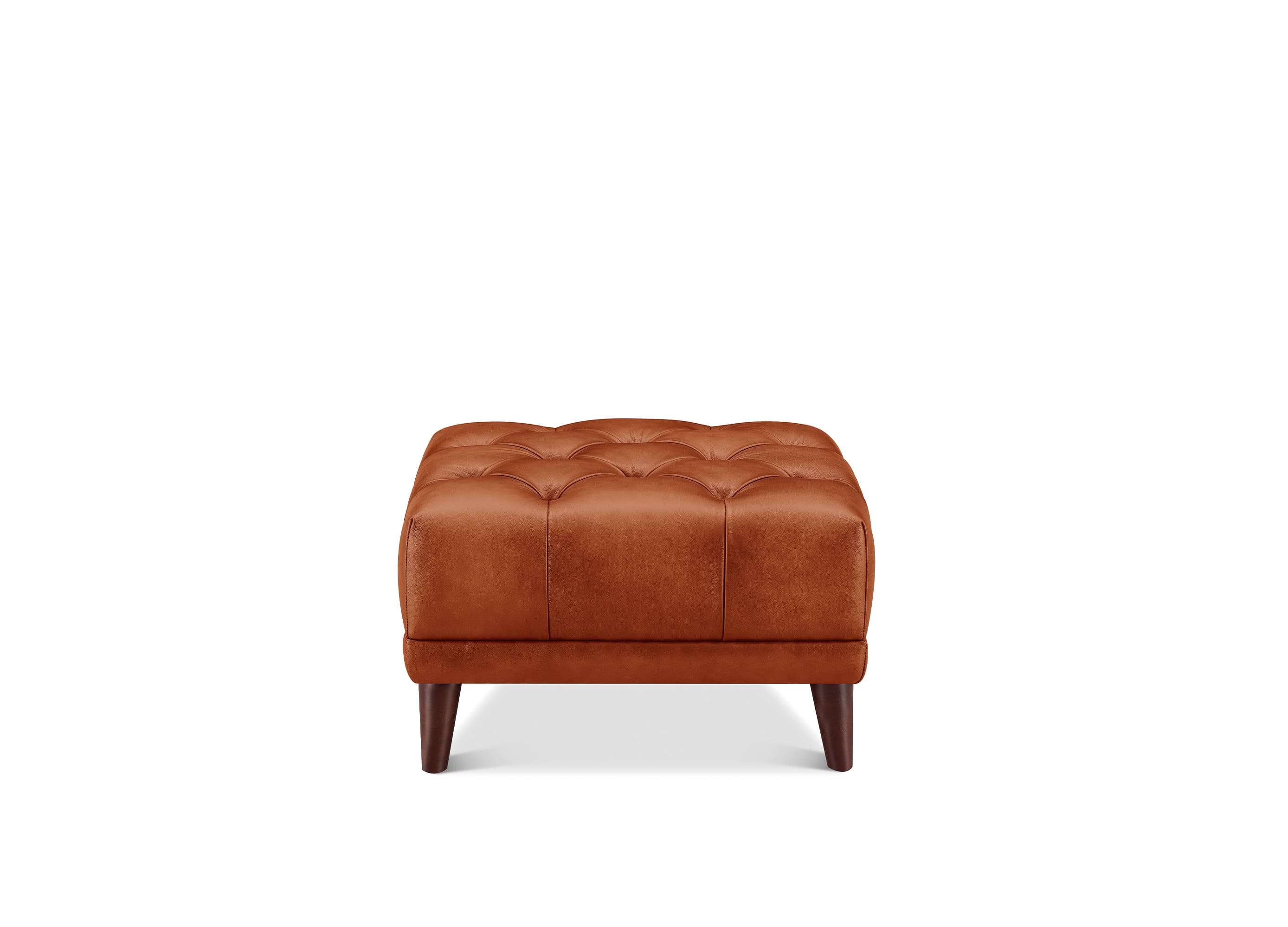 A square tufted leather ottoman in a warm cognac brown, supported by four dark wooden legs, shown against a plain white background.