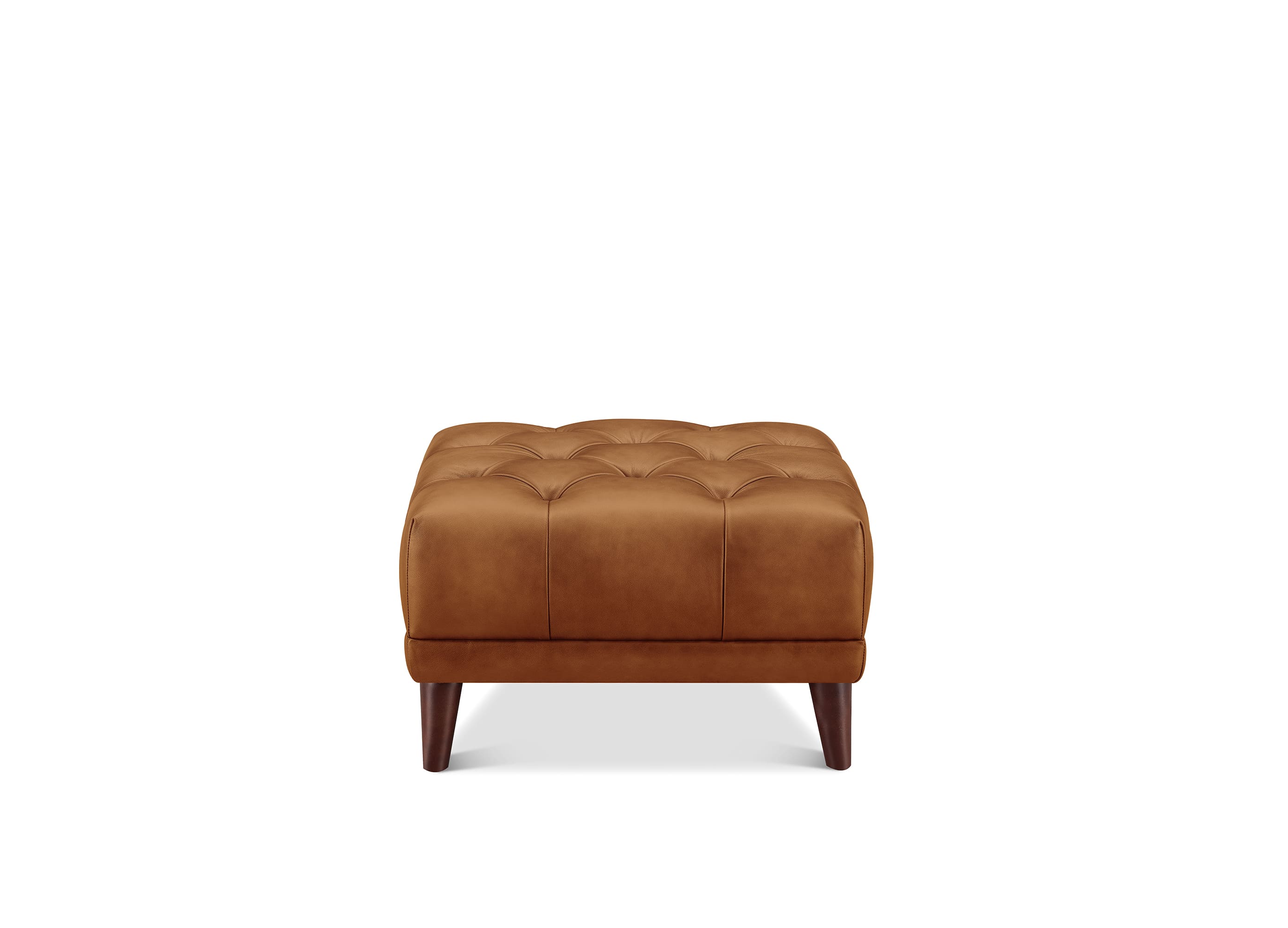A square tufted leather ottoman in a warm cognac brown, supported by four dark wooden legs, shown against a plain white background.