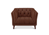 A brown tufted leather armchair with rolled arms and tapered wooden legs, shown against a plain white background.