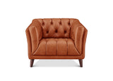 A classic Chesterfield-style armchair upholstered in warm cognac brown leather, featuring deep button tufting on the backrest and seat, rolled arms, and dark tapered wooden legs, shown against a plain white background.