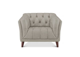 A light beige tufted armchair with dark brown wooden legs, shown from a front-facing perspective on a white background.