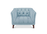A light blue tufted armchair with dark brown wooden legs, shown from a front-facing perspective on a solid white background.