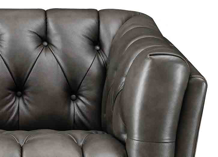 Brown leather sofa with tufted backrest on a white background