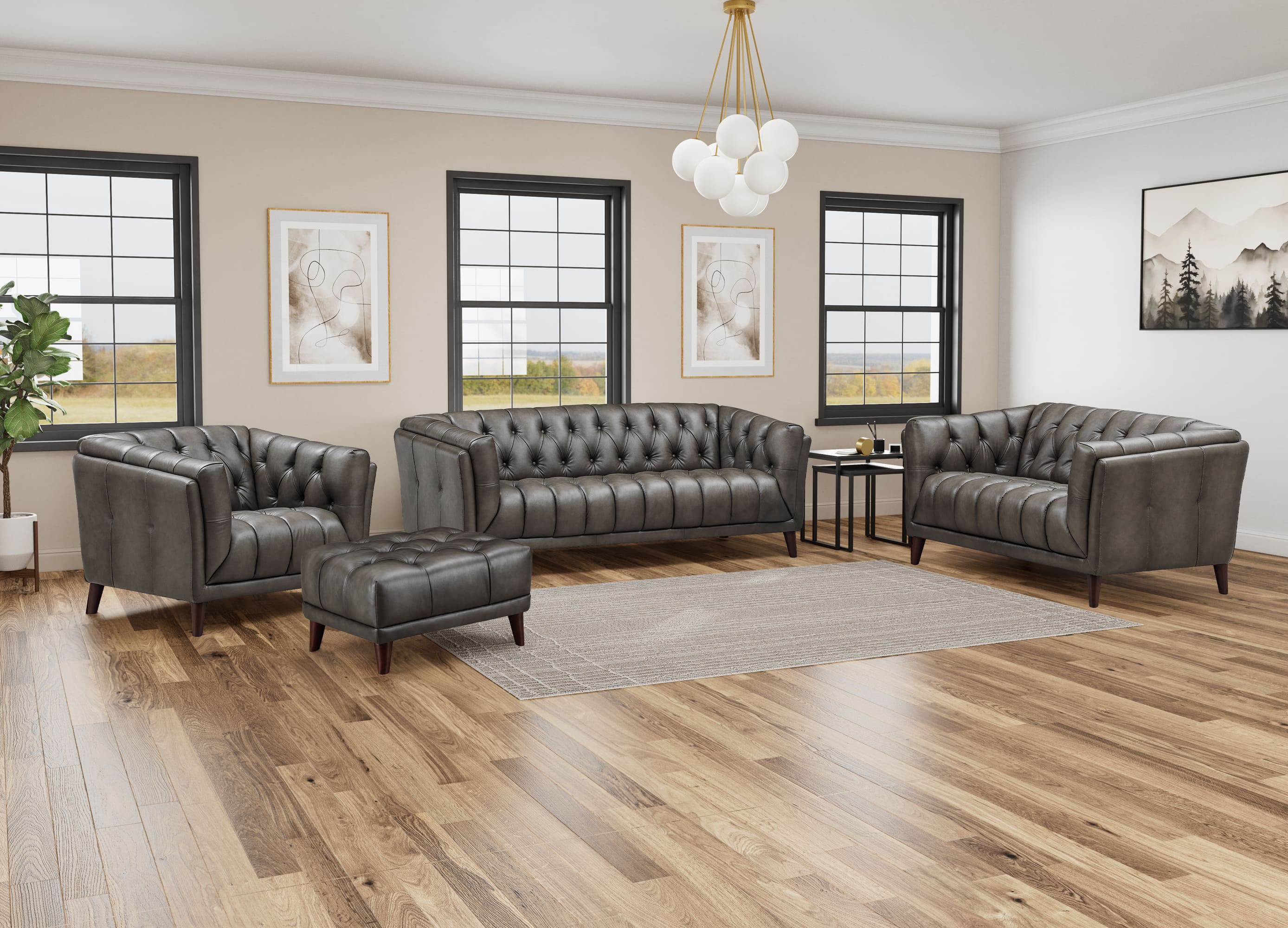 A staged living room showing a dark gray tufted leather furniture set, including a sofa, two armchairs, and a matching ottoman, arranged on a light gray rug over a wood floor.
