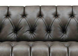 Brown leather sofa with tufted backrest on a white background