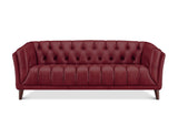 A classic Chesterfield-style sofa upholstered in deep burgundy leather, featuring a tufted backrest and channel-tufted seat, supported by dark wooden legs, shown against a plain white background.