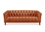 A classic Chesterfield-style leather sofa in a warm cognac brown, featuring deep button tufting on the backrest and seat, rolled arms, and dark tapered wooden legs, shown against a plain white background.