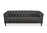 A dark gray tufted leather sofa with rolled arms and dark wooden legs, shown from a front-facing perspective on a white background.