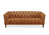 A classic Chesterfield-style loveseat sofa upholstered in warm camel brown leather, featuring deep button tufting on the backrest and seat, rolled arms, and dark wooden legs, shown against a plain white background.