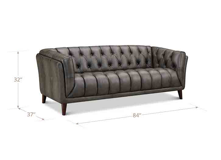 Gray tufted sofa with dimensions on a white background