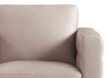 Close-up of a beige armchair with a blurred background