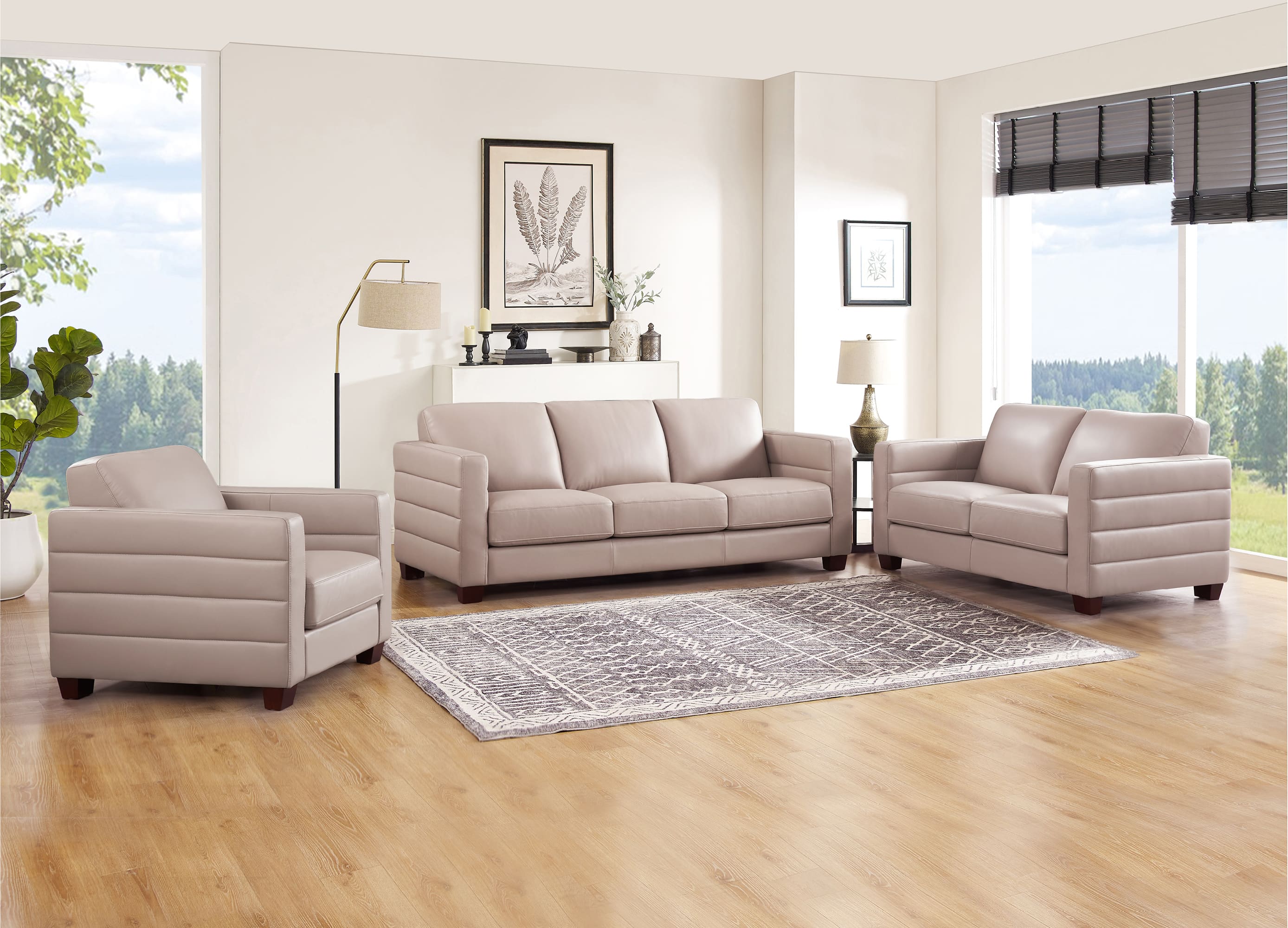 Gray sofa set in a living room with large windows and decor.