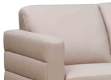 Beige sofa with a focus on the armrest and backrest.
