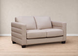 A two-seater loveseat sofa upholstered in light beige leather, featuring horizontal channel tufting on the arms and dark wooden legs, set against a neutral beige textured wall and light wood floor.