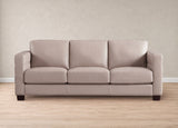 A three-seat upholstered sofa in a light beige or taupe fabric, shown from the front against a neutral beige wall and light wood floor.