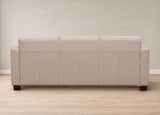 A three-seat sofa upholstered in light beige leather, shown from the back against a textured beige wall and light wood floor.
