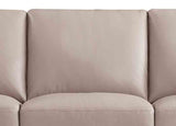 Close-up of a beige sofa with a plain background