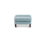 A square ottoman with a light blue textured fabric top and dark brown wooden legs, shown against a plain white background.
