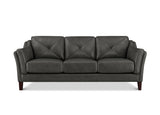 A three-seat sofa upholstered in dark charcoal gray leather with diamond-quilted back cushions and tufted arm details, supported by dark wooden legs, shown against a plain white background.