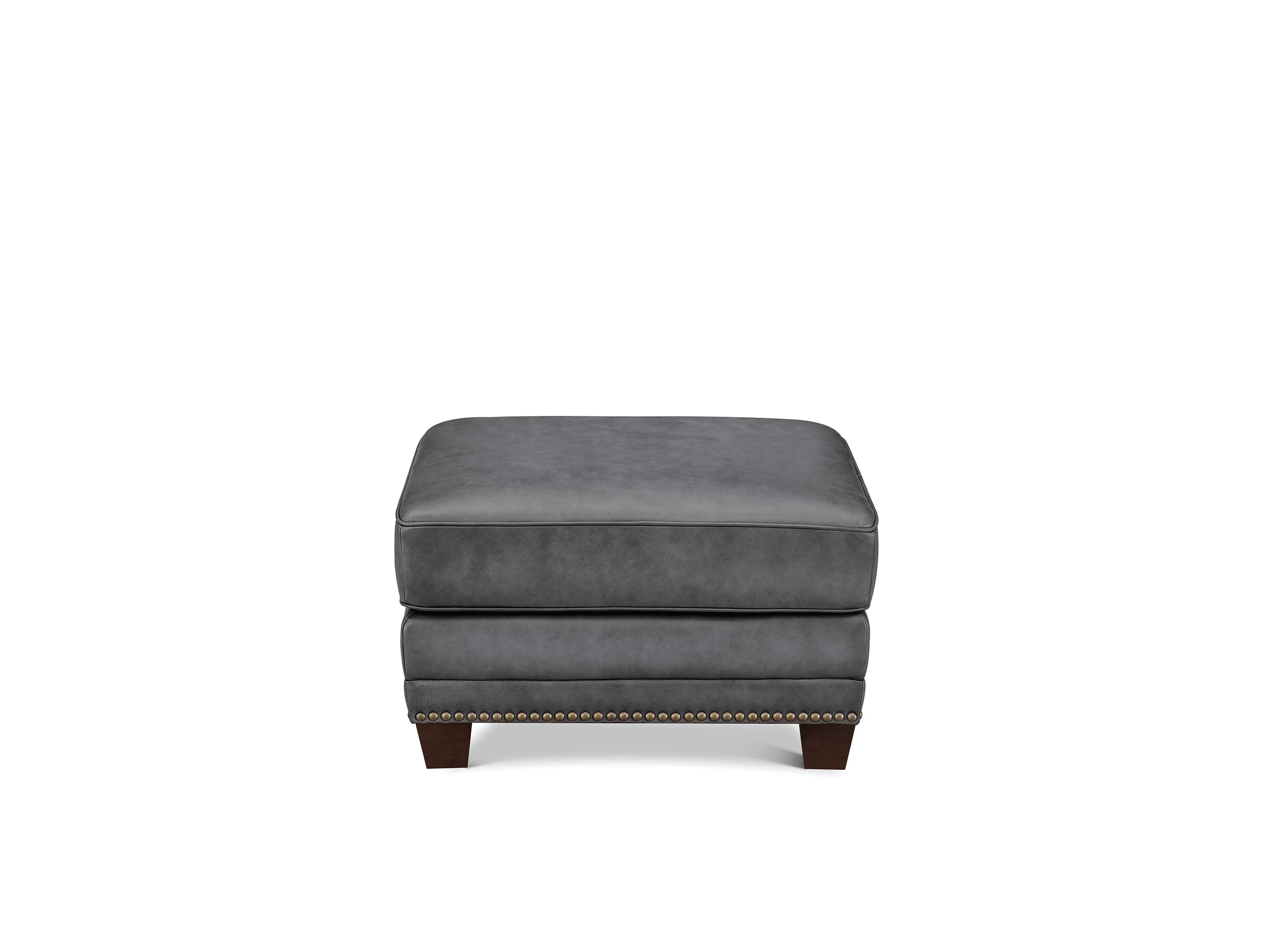 A dark gray upholstered ottoman with a tiered design and dark brown wooden legs, accented with nailhead trim along the front edge, shown against a plain white background.