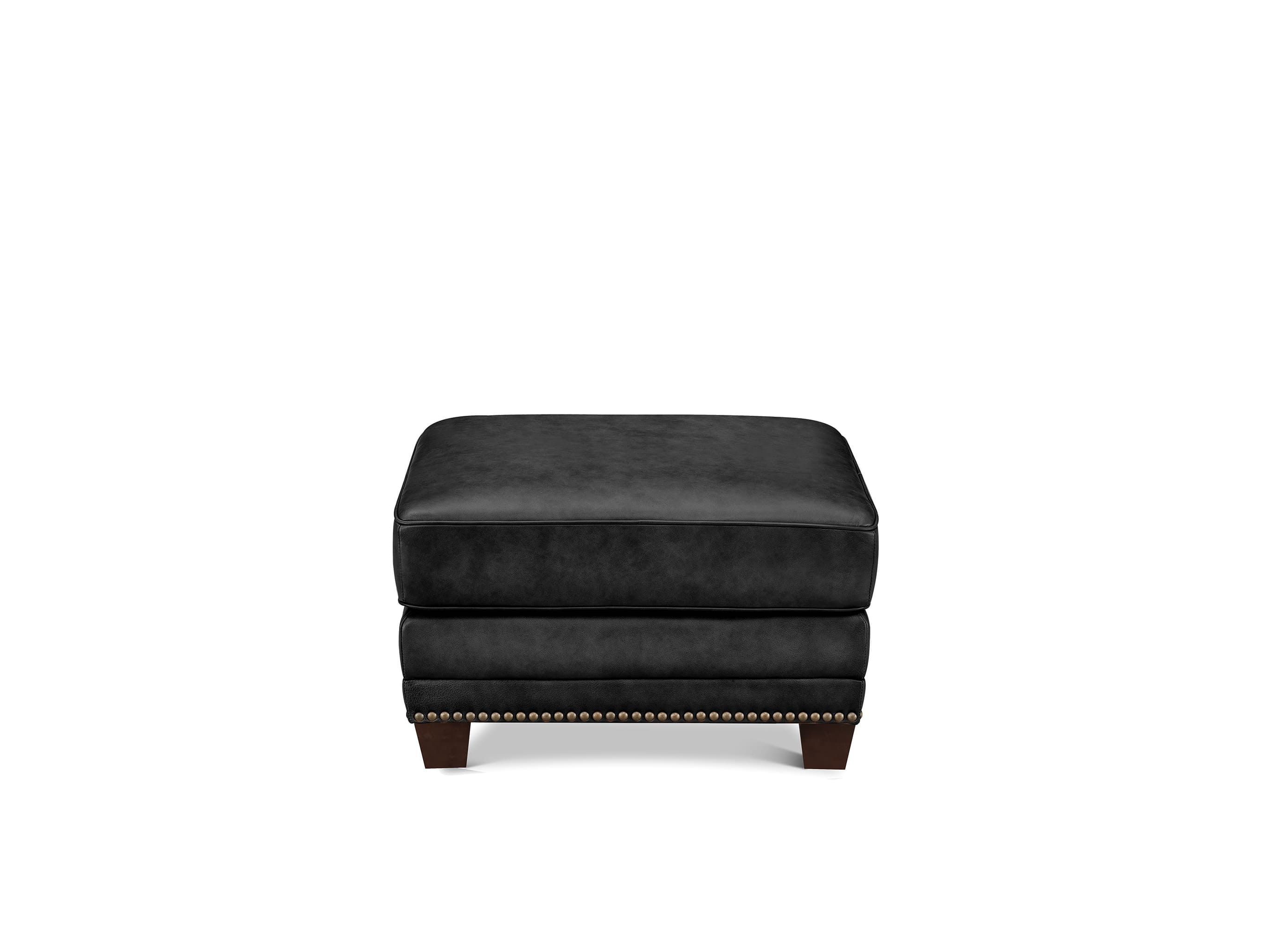 A black upholstered ottoman with dark wood legs and nailhead trim, shown against a plain white background.