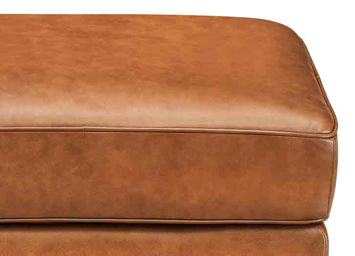 Brown leather ottoman on a white background