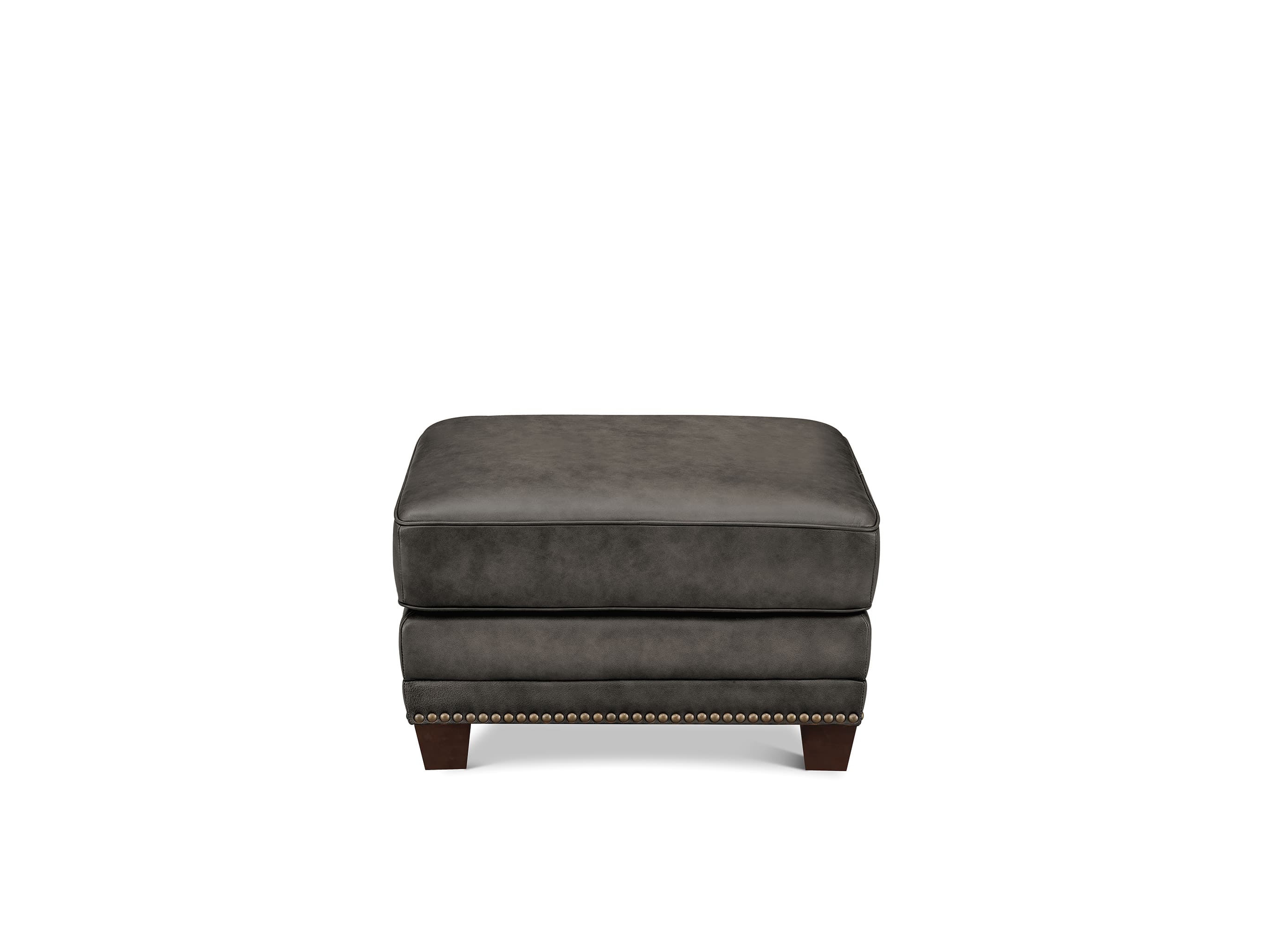 A dark gray upholstered ottoman with a stacked two-seat design, featuring a tufted top, nailhead trim along the front edge, and short dark wooden legs, shown against a plain white background.