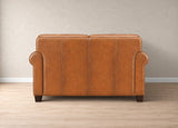 A classic two-seater sofa upholstered in warm cognac brown leather, shown from the back against a neutral beige wall and light wood floor.
