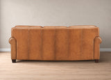 A three-seater sofa upholstered in warm tan leather, shown from the back against a neutral beige wall and light wood floor.