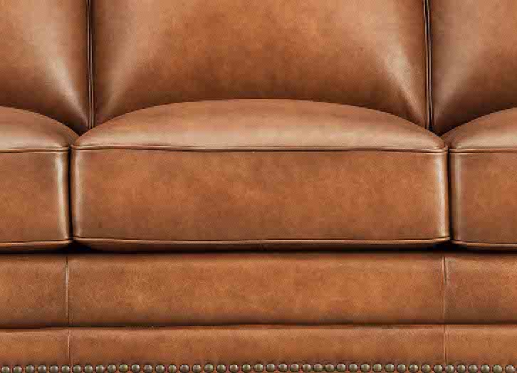Close-up of a brown leather sofa with visible stitching